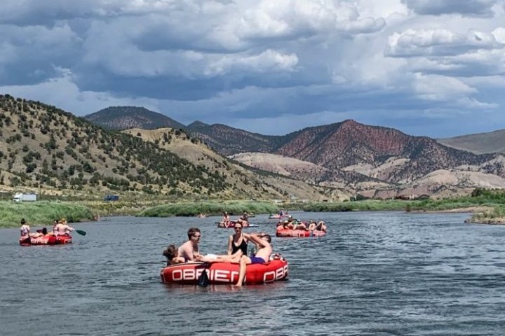 a group of people in a small boat in a body of water