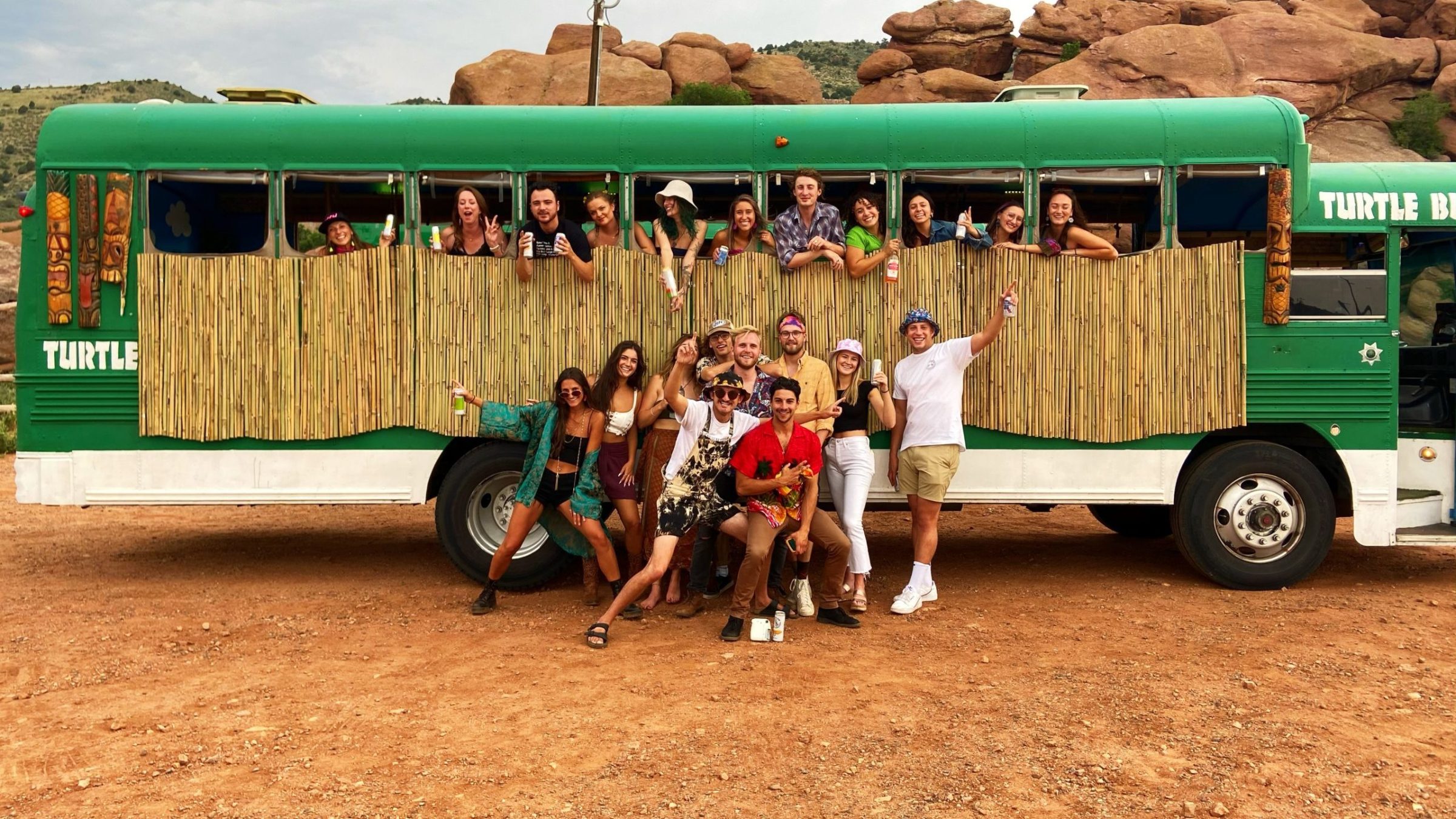 a group of people standing in front of a bus